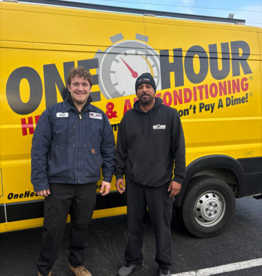 Photo of employees in front of a work truck